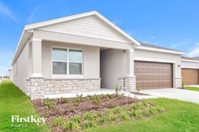 Bartow house for rent - a house with a driveway and a garage door