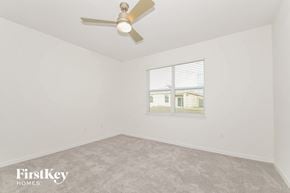 Bartow house for rent - the living room of a home with a ceiling fan and a window