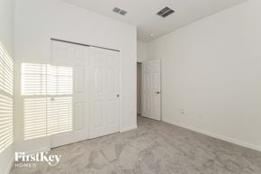 Bartow house for rent - a bedroom with white walls and white doors and a carpeted floor