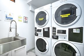 Montréal apartment for rent - A washing machine and a washing machine with a yellow caution tape on it.