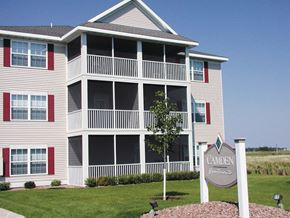 Sauk Rapids apartment for rent - a view of a condo building with a sign in front of it