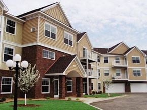 Sartell apartment for rent - a row of houses with balconies and a street light