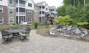 St Cloud apartment for rent - a patio with a fire pit in front of an apartment building