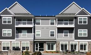St Cloud apartment for rent - a large apartment building with a patio in front of it