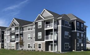 St Cloud apartment for rent - a large apartment building with a blue sky in the background