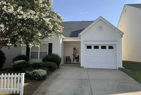 Simpsonville house for rent - a white house with a driveway and a white fence