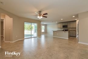 Winter Haven house for rent - an empty kitchen and living room with a ceiling fan