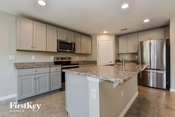 Winter Haven house for rent - a kitchen with granite counter tops and stainless steel appliances