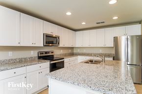 Winter Haven house for rent - A kitchen with granite countertops and stainless steel appliances.