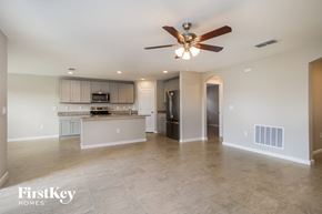Winter Haven house for rent - an open kitchen and living room with a ceiling fan