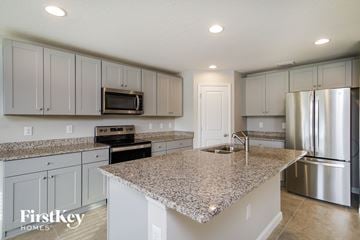 Winter Haven house for rent - a white kitchen with granite counter tops and stainless steel appliances