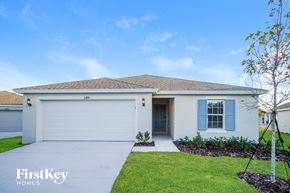 Winter Haven house for rent - a white house with blue shutters and a driveway
