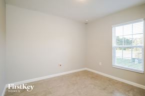 Winter Haven house for rent - a bedroom with a large window and a tiled floor