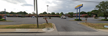 Charlotte apartment for rent - a parking lot in front of a shopping center with a gas station