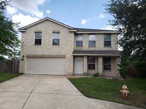 Brownsville house for rent - a brick house with a white garage door and a fire hydrant in the yard