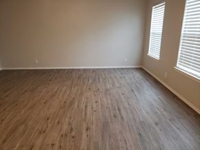 Brownsville house for rent - a living room with wood floors and white walls