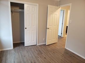 Brownsville house for rent - a bedroom with two doors and a closet and a hard wood floor
