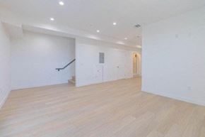 Inglewood apartment for rent - a empty living room with white walls and a wooden floor
