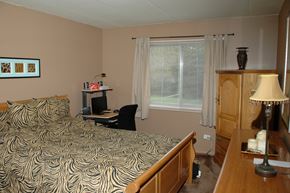 West Chicago apartment for rent - A bedroom with a bed, desk, and chair.