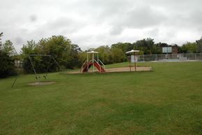 West Chicago apartment for rent - A playground with a swing set and a seesaw.