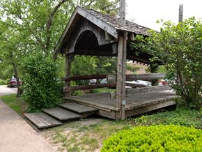 Carol Stream apartment for rent - A wooden shelter with a roof and a sign on it.