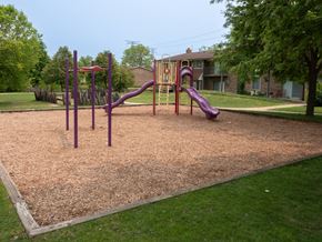 Carol Stream apartment for rent - A playground with a purple slide and a purple swing set.