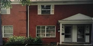 Dearborn Heights apartment for rent - A red brick house with a white door and windows.