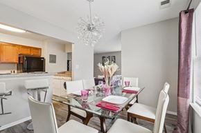 Monmouth Junction apartment for rent - A dining room with a glass table and white chairs.