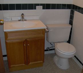 Broadview apartment for rent - A white toilet sits next to a sink in a bathroom.