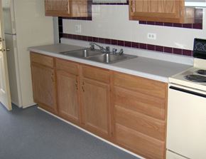Broadview apartment for rent - A kitchen with wooden cabinets and a white oven.