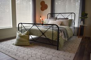 Portland apartment for rent - a bedroom with a bed and a rug and two windows