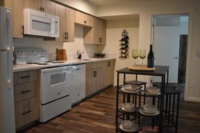 Portland apartment for rent - a kitchen with white appliances and a table with chairs