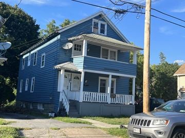 Syracuse apartment for rent - a blue house with a car parked in front of it