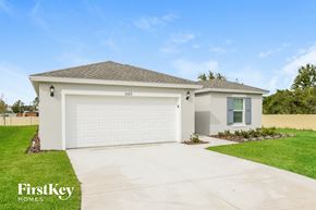 Davenport house for rent - a home with a white garage door and a driveway