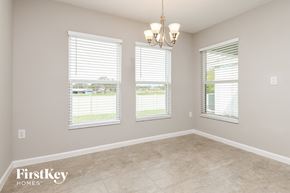 Davenport house for rent - a dining room with three windows and a tile floor
