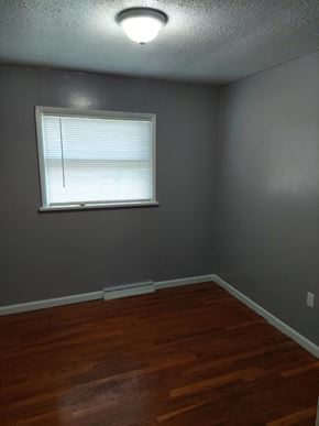 Morrow house for rent - a small room with a window and wooden floors