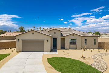 Indio house for rent - a house with a driveway and a garage door
