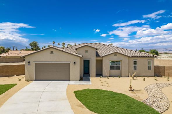 Indio house for rent - a house with a driveway and a garage door