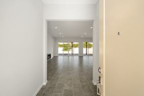 Indio house for rent - the living room of a house with white walls and tiled floors