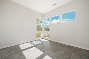 Indio house for rent - an empty living room with windows and a tile floor