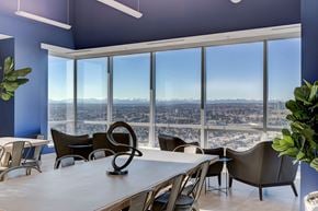 Calgary apartment for rent - a conference room with a view of the city and a table and chairs