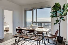 Calgary apartment for rent - a dining room with a table and chairs and a large window