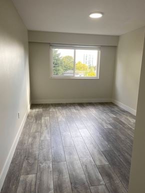 Nanaimo apartment for rent - A room with a window and wooden flooring.