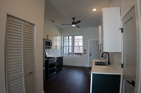 Chicago apartment for rent - A kitchen with a white fridge and black cabinets.