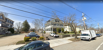 Salem apartment for rent - a house on the corner of a street with cars and a truck