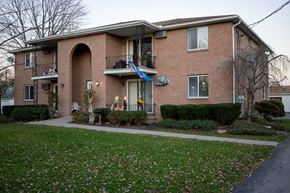 North Tonawanda apartment for rent - a brick house with a yard in front of it