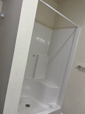 Paris apartment for rent - A white bathroom with a white shower stall.