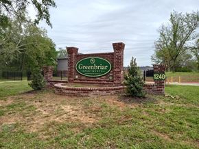 Paris apartment for rent - A brick sign that says Greenbriar stands in a field.