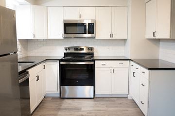Niagara Falls apartment for rent - a white kitchen with stainless steel appliances and white cabinets