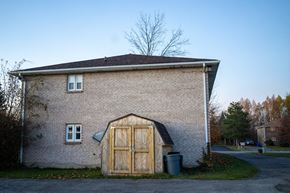 Niagara Falls apartment for rent - the side of a brick building with a barn door